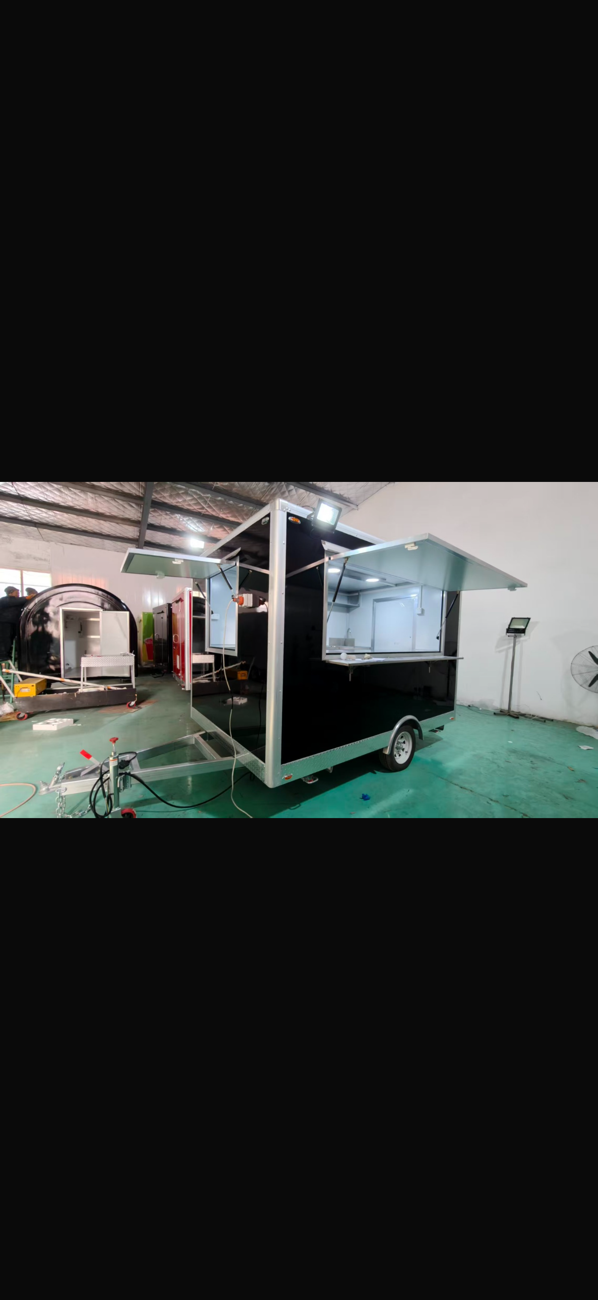 Black food trailer serving window open